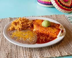 Cheese-topped enchiladas with rice and beans